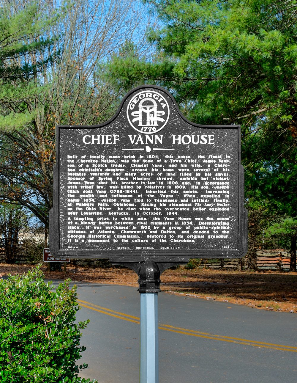 Black cast-metal Georgia historical marker headed “Chief Vann House” beside a road.